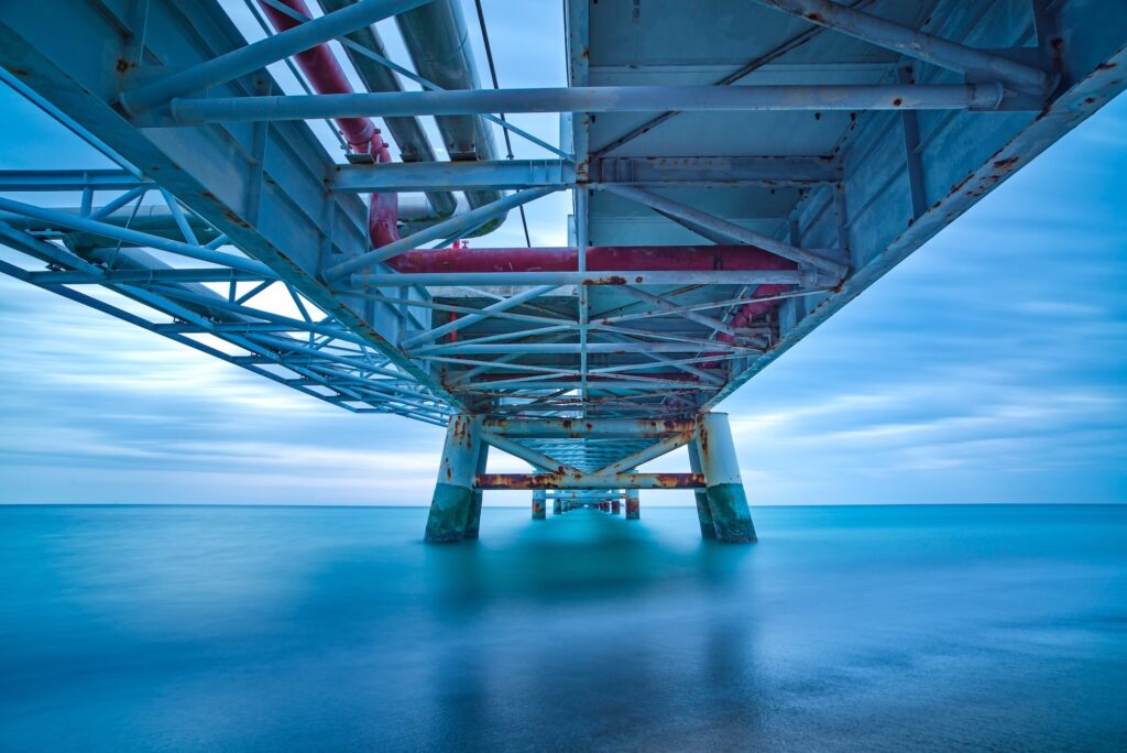 Industrial pier on the sea. Bottom view. Long exposure photography.