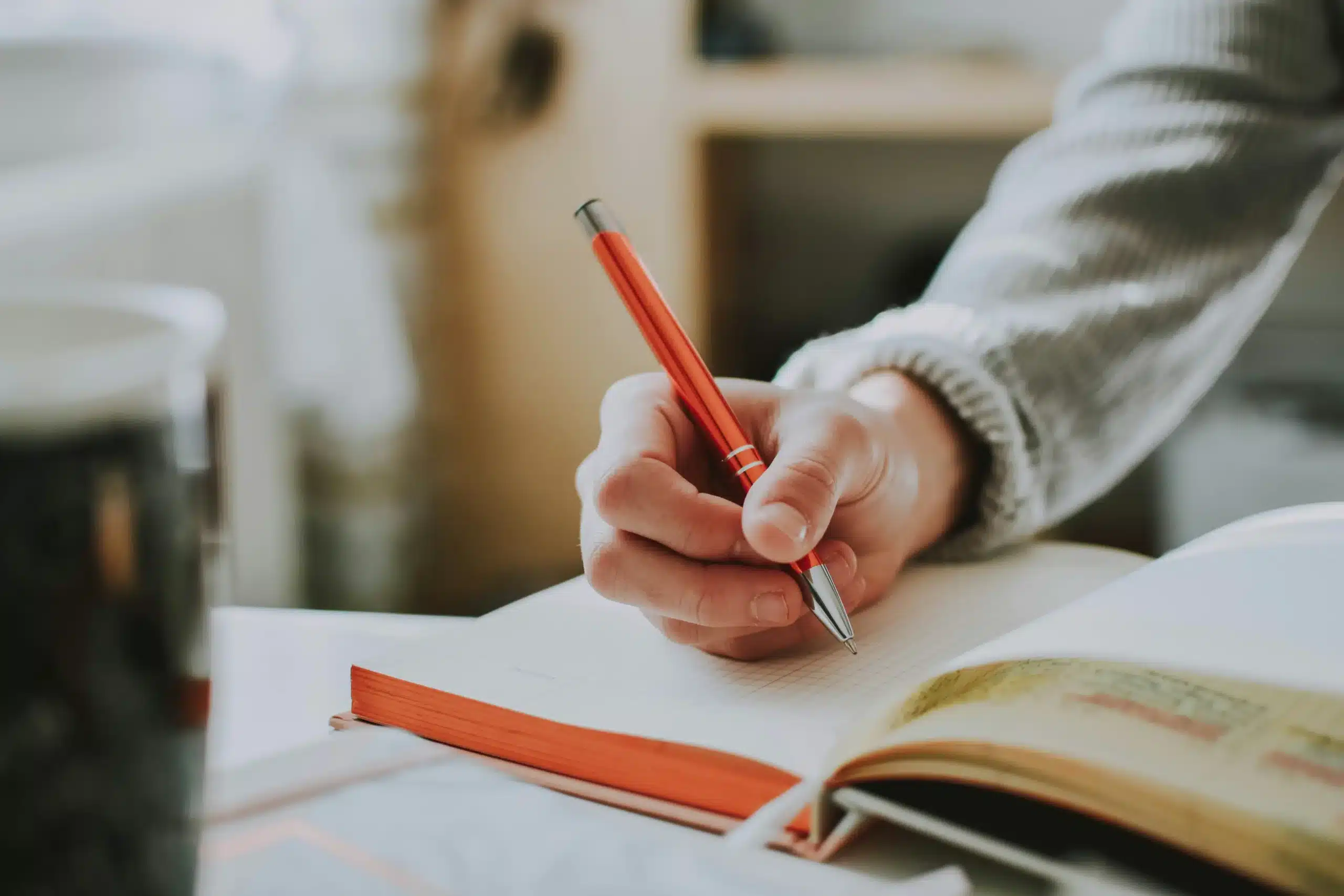 A hand writing on a piece of paper.